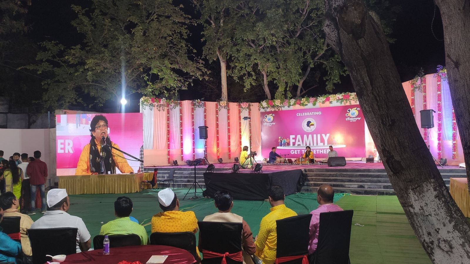 Open-air concert with a seated audience on the lawn