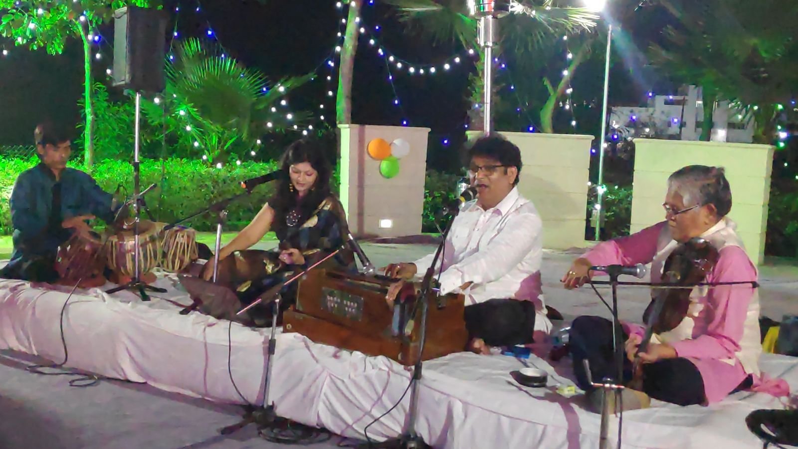 Garden-lawn mehfil at night with the full ensemble