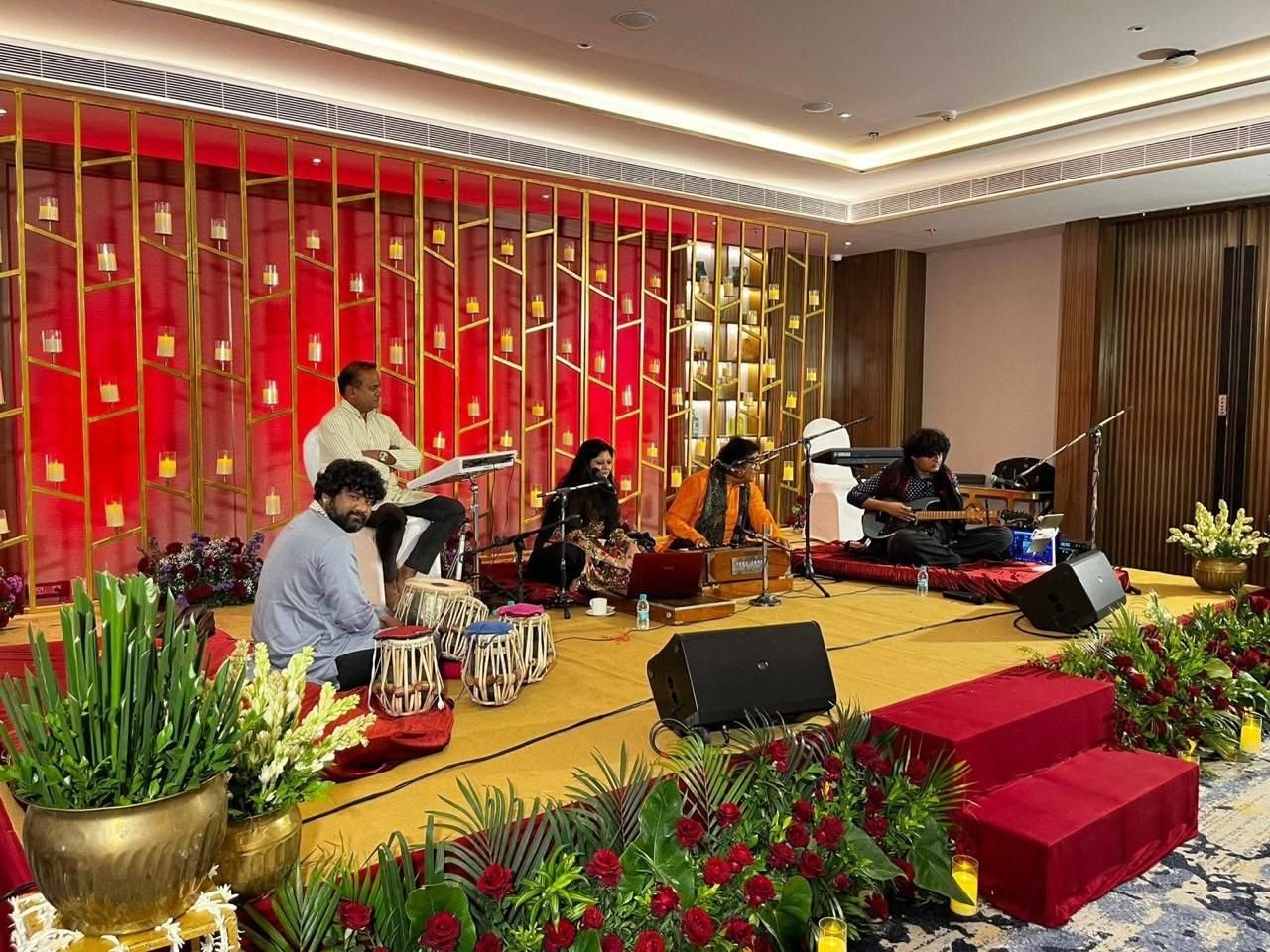 Stage set with a starry LED screen and red carpet, waiting for the mehfil